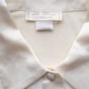 Etiquette de la chemise blanc cassé satinée pour femme, taille S à M.