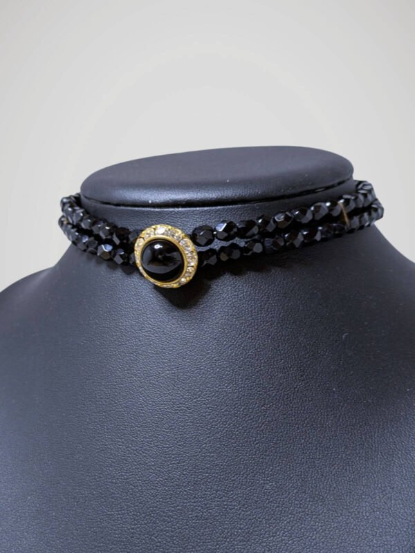 Zoom sur le chocker vintage noir et doré, vue de côté.