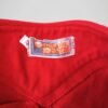 Zoom sur l'étiquette du pantalon rouge évasé en laine vintage années 70, pour femme, taille S à M.