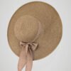 Chapeau de paille large pour femme, style bohème pour l'été, orné d'un noeud, vue de côté.